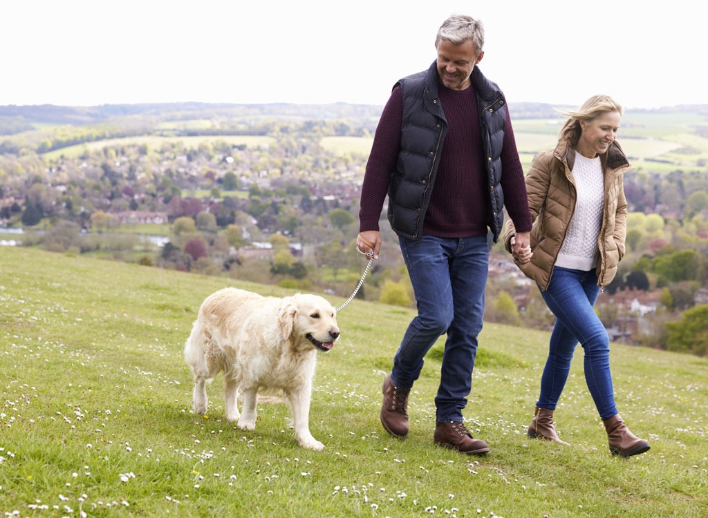 Older couple walking dog