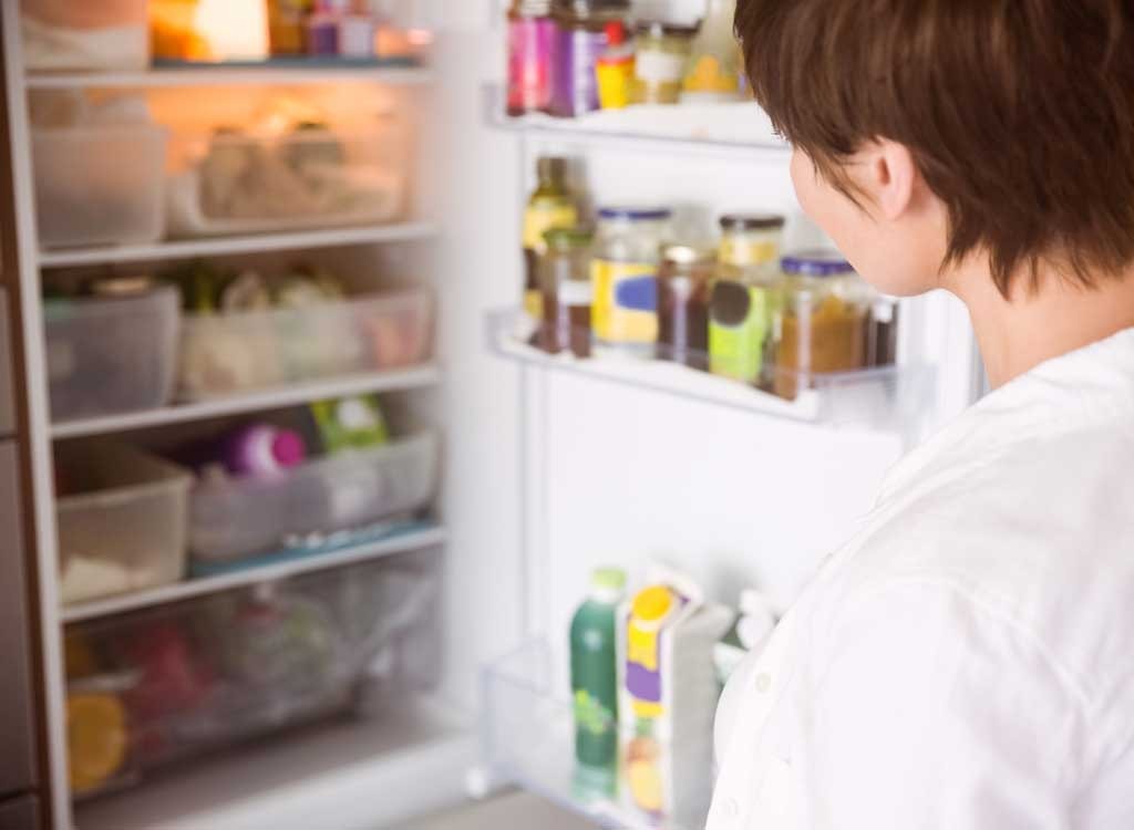 woman looking into fridge