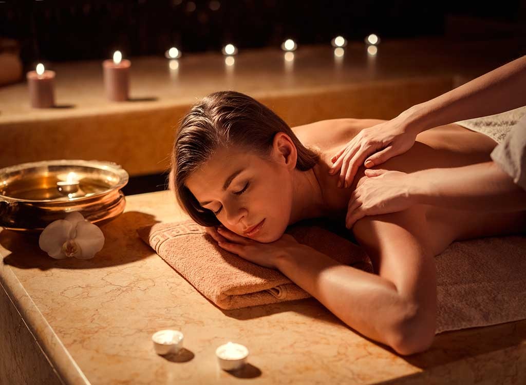woman getting massage candles