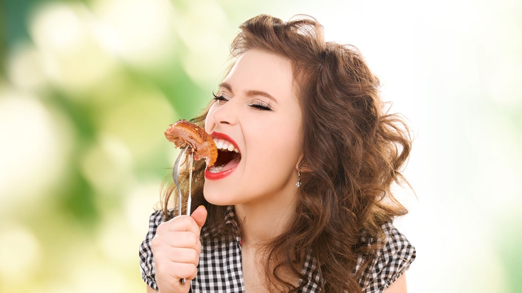 woman eating meat