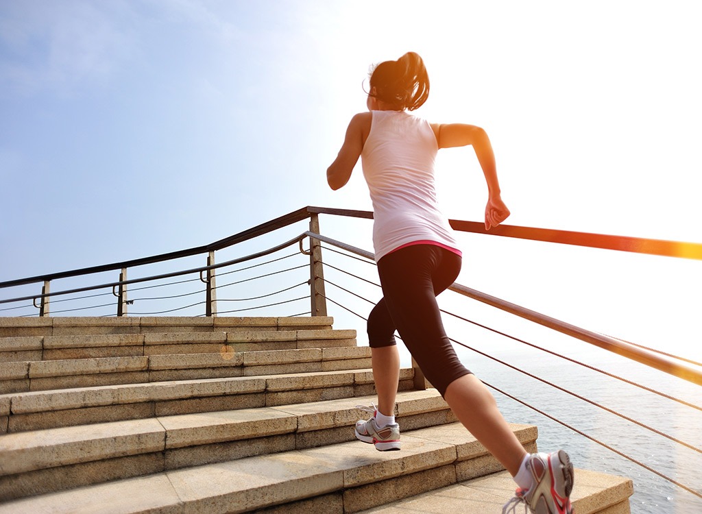 Woman running up stairs