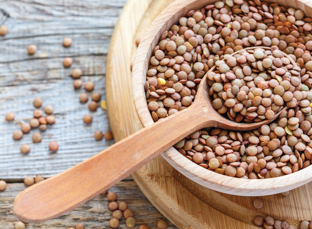 bowl of lentils with wooden spoon