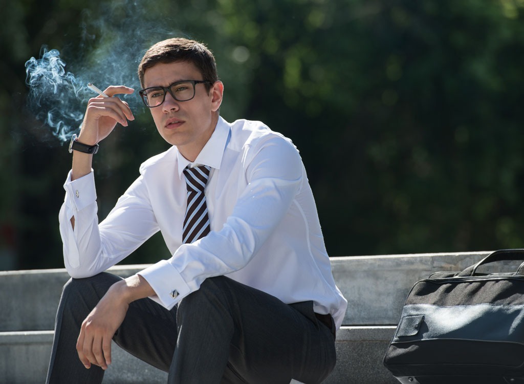 man in suit smoking