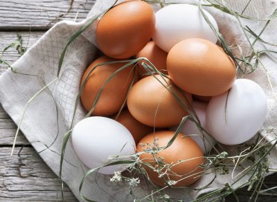 Brown and white eggs in basket
