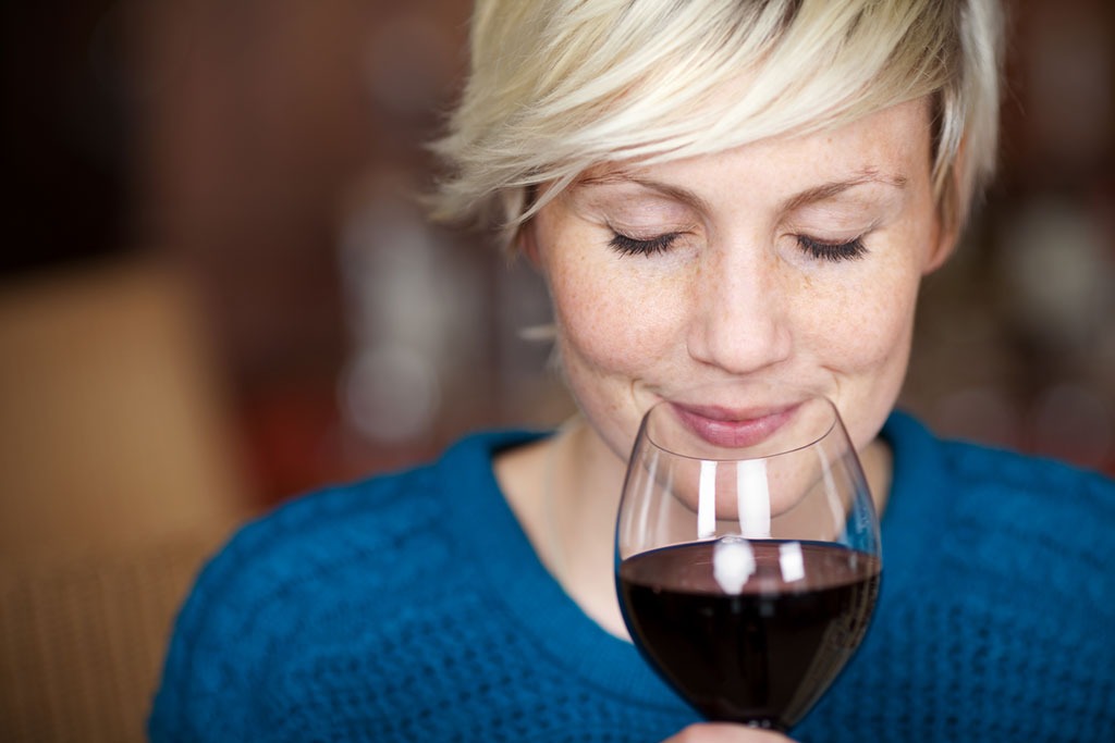 Woman smelling wine