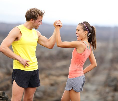 Fit man and woman high five