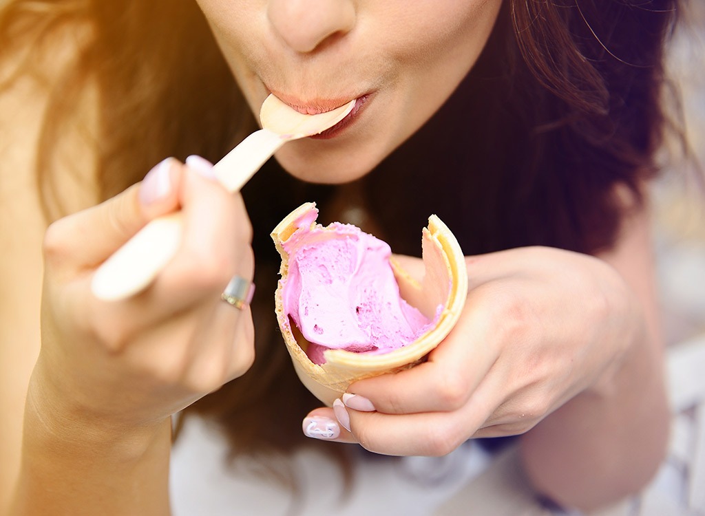woman spooning ice cream cone
