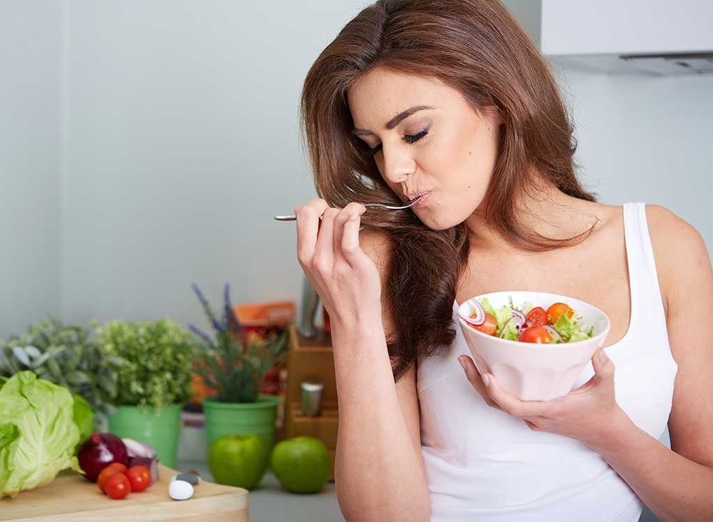 woman eating salad