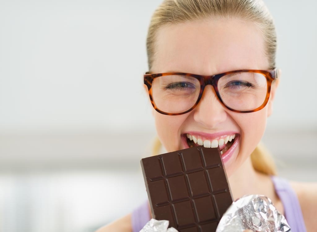 Woman eating dark chocolate