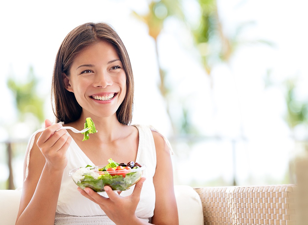 Woman eating salad - best ways to speed up your metabolism