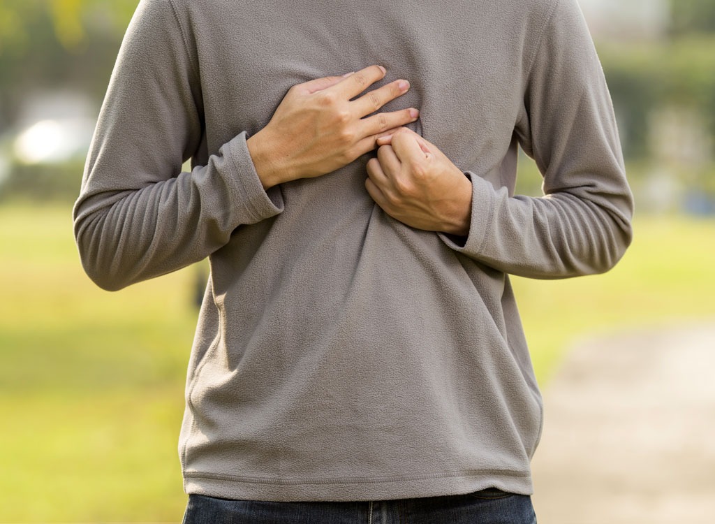 man holding chest in pain