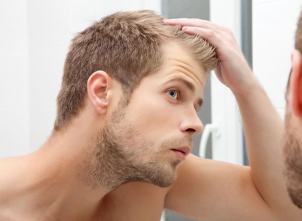 man looking at hair