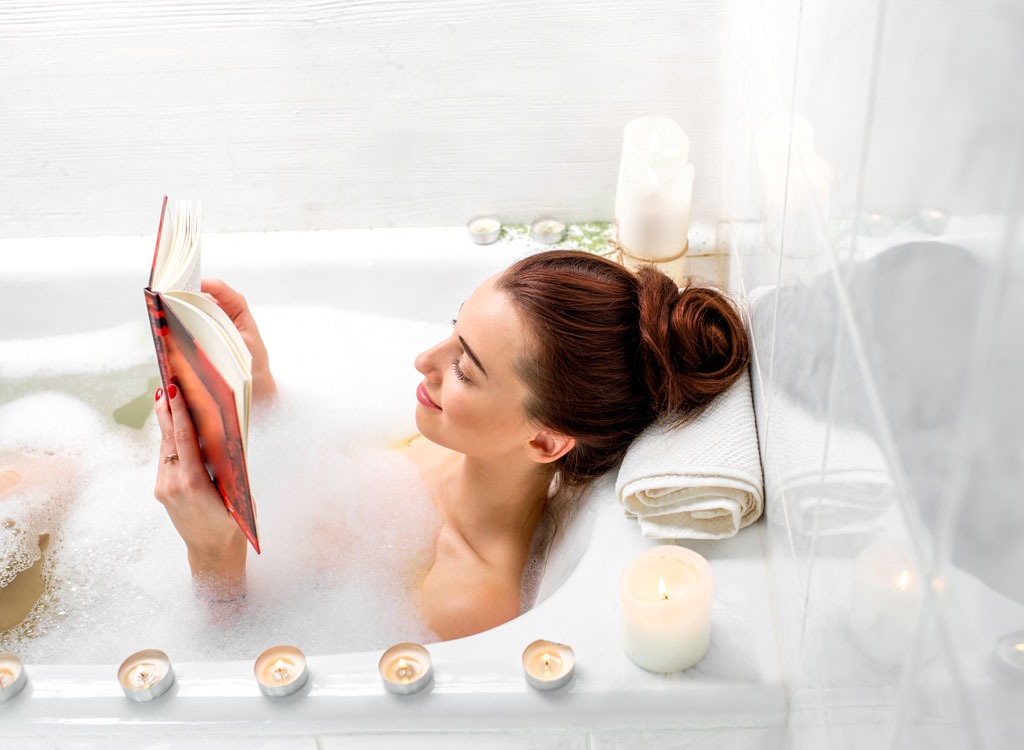 woman reading bath relax