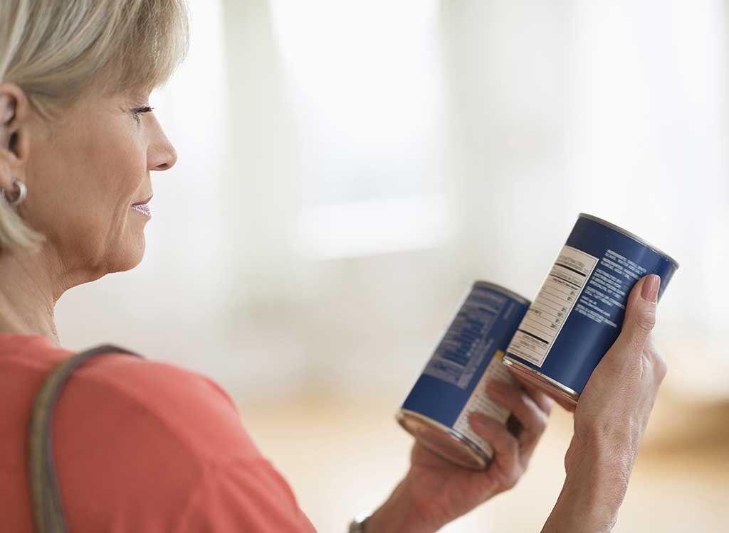 woman looking at can labels