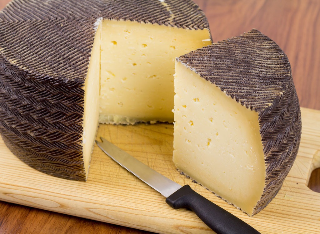 wedge of manchego cheese with knife