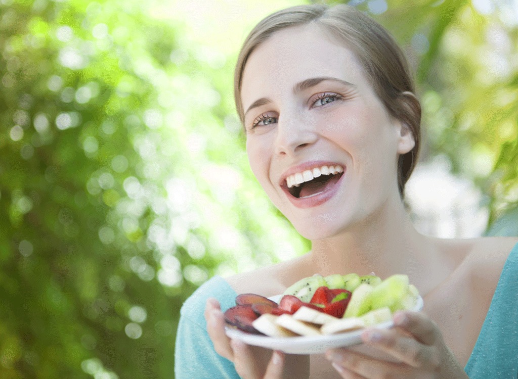 Happy woman with fruit