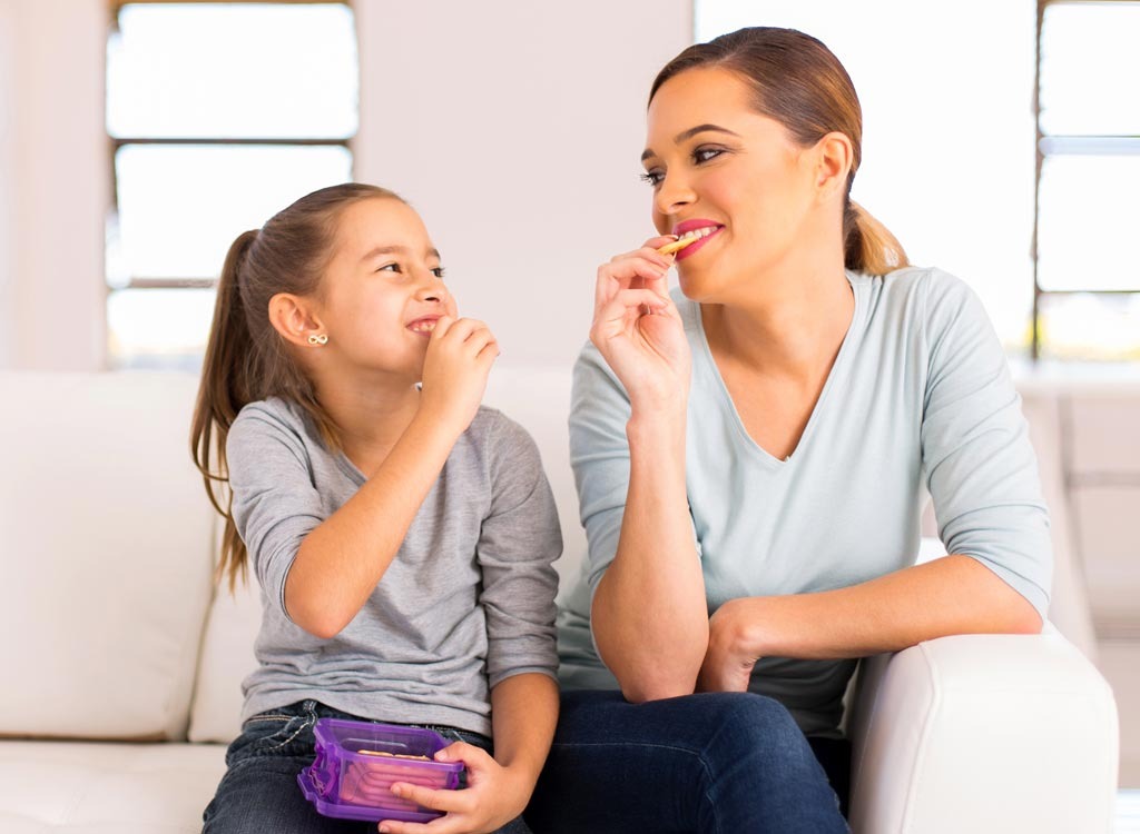 mom and daughter snacking