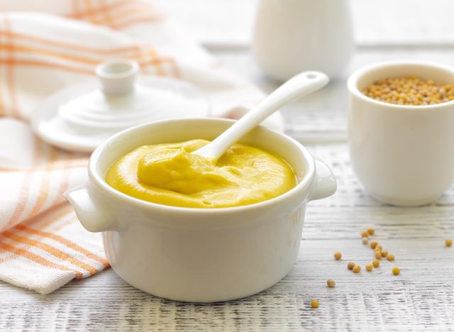 Mustard in the serving dish with spoon