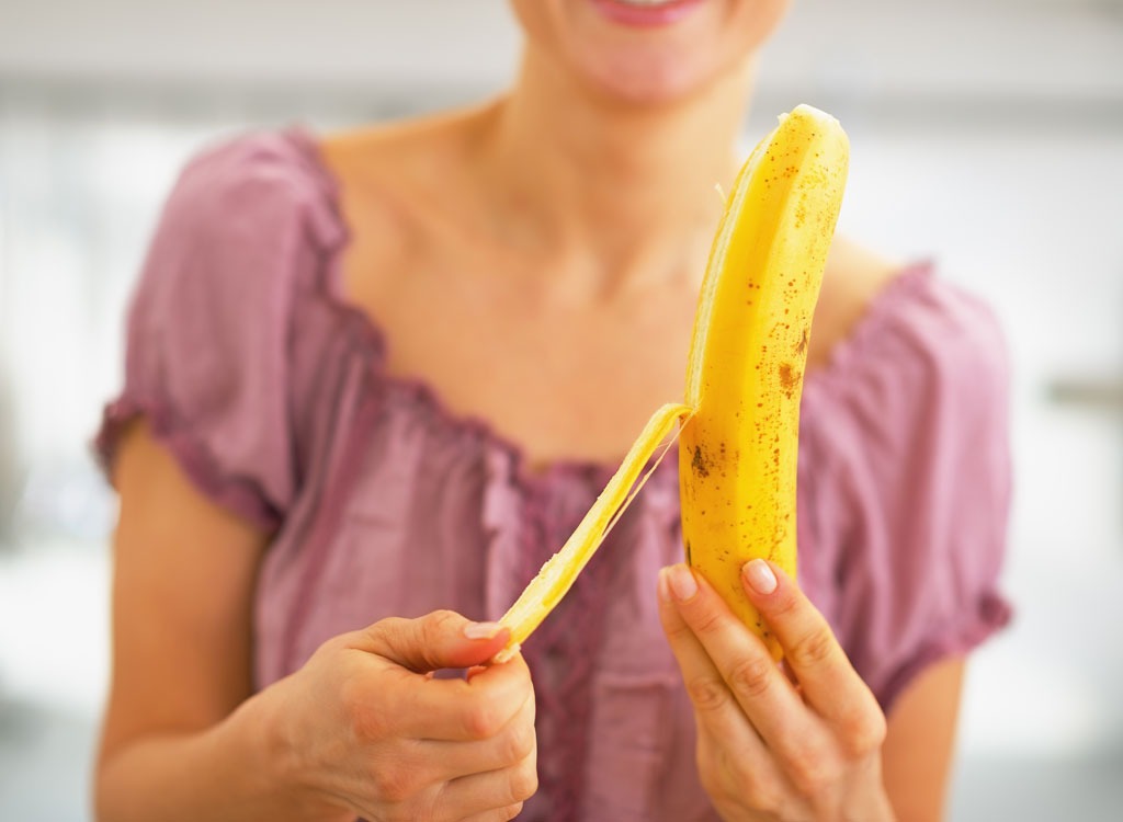 Woman peeling banana