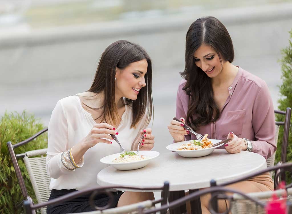 Women talking eating salad