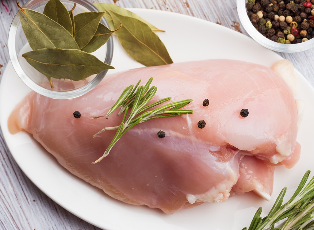 raw chicken on plate with seasoning