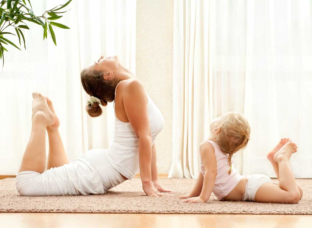 mom and daughter doing yoga