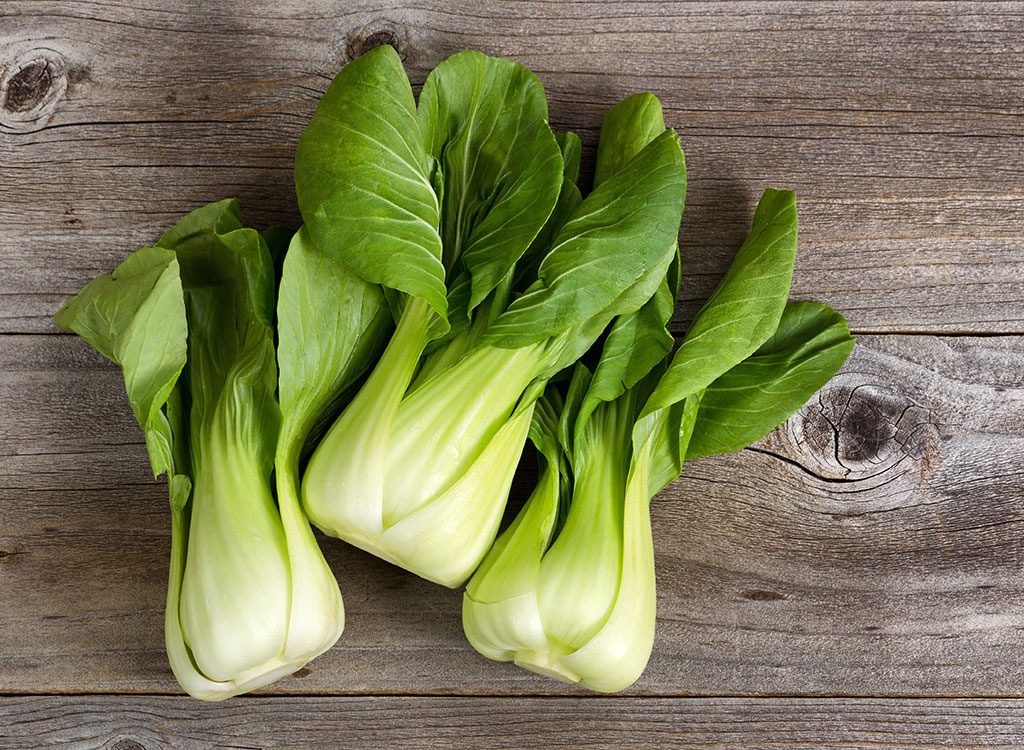 bunches of bok choy on rustic table