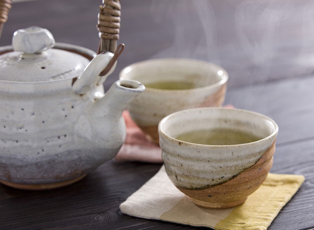 teapot with two cups of green tea