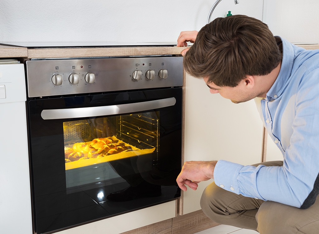 Casserole tips man using oven