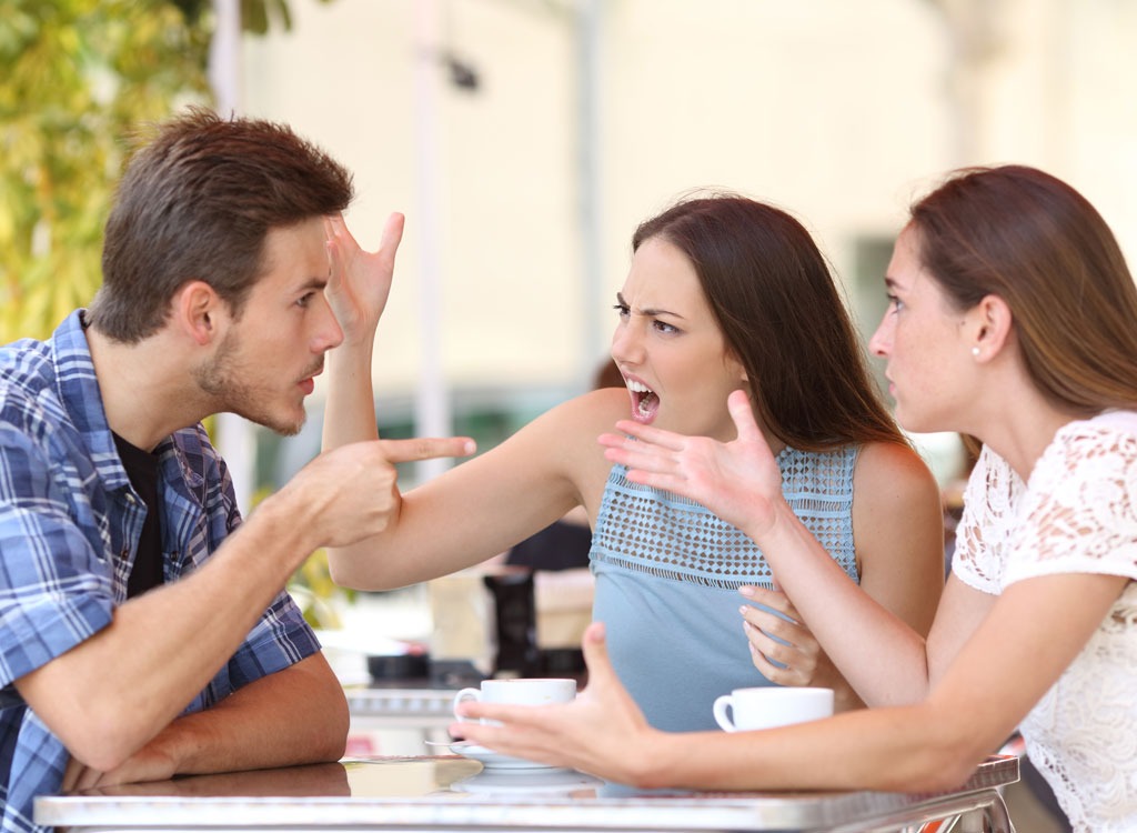 Friends arguing at table