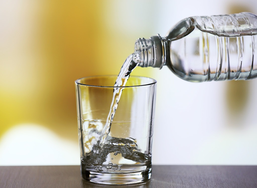 bottled water pouring into glass