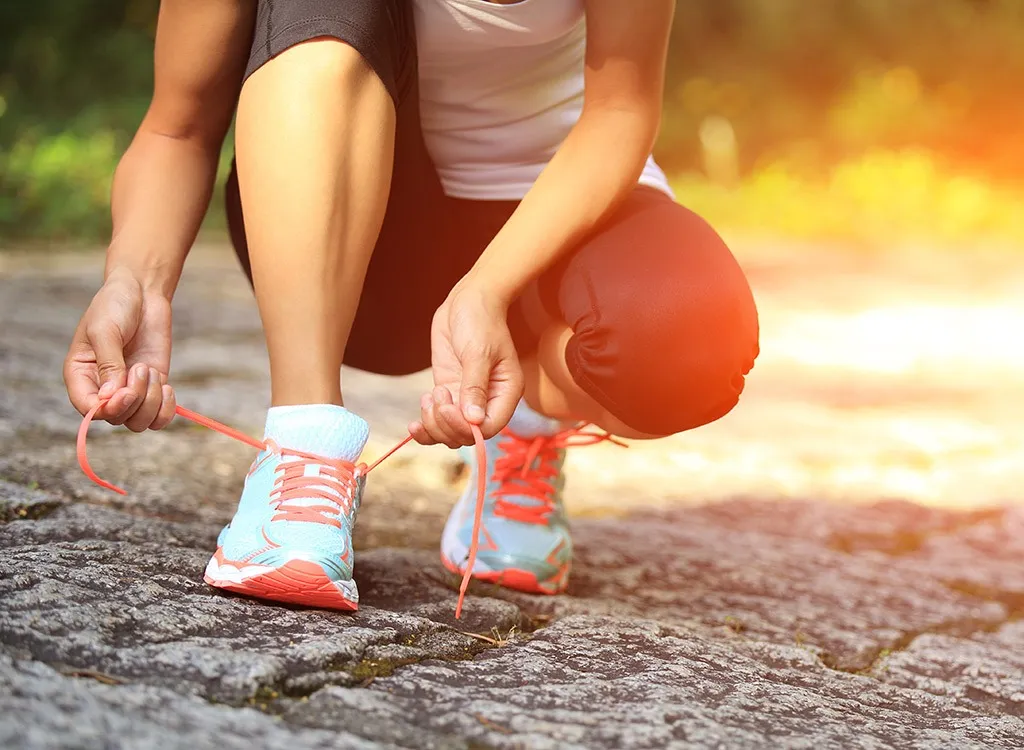 Woman tying shoes