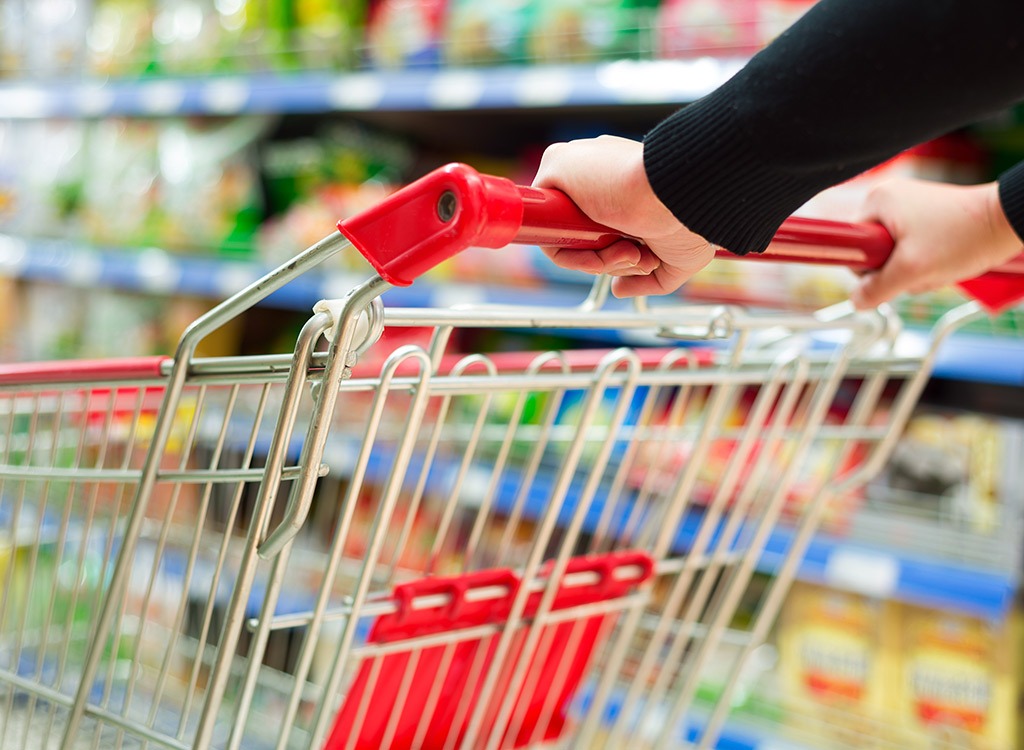 pushing grocery cart through store