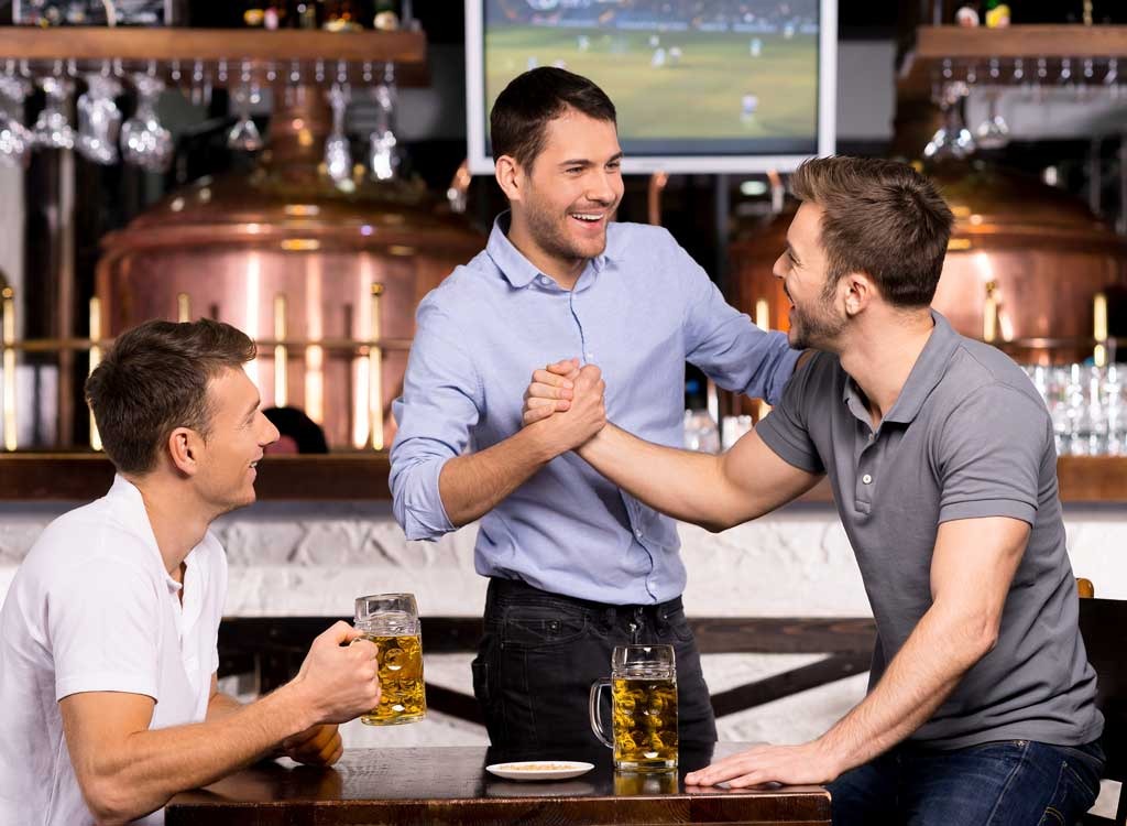 Men greeting each other at bar