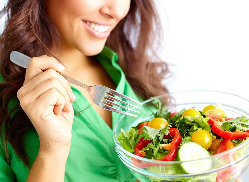 Woman eating salad