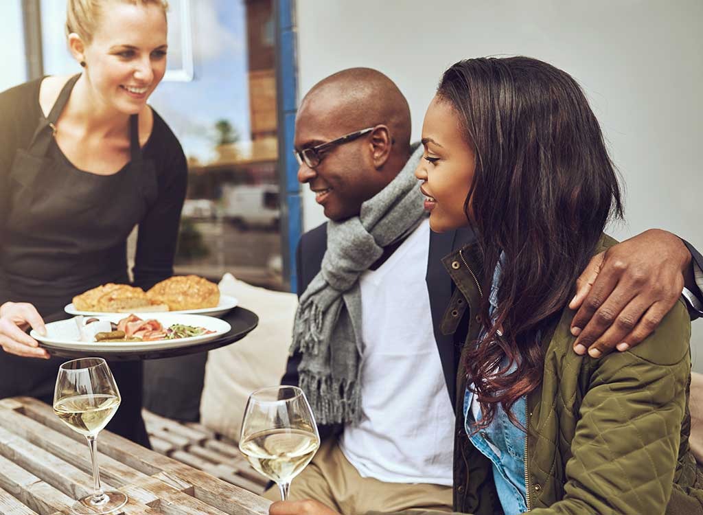 couple at restaurant with waitress