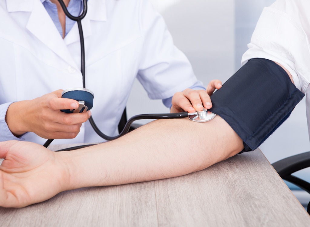 Doctor taking blood pressure reading