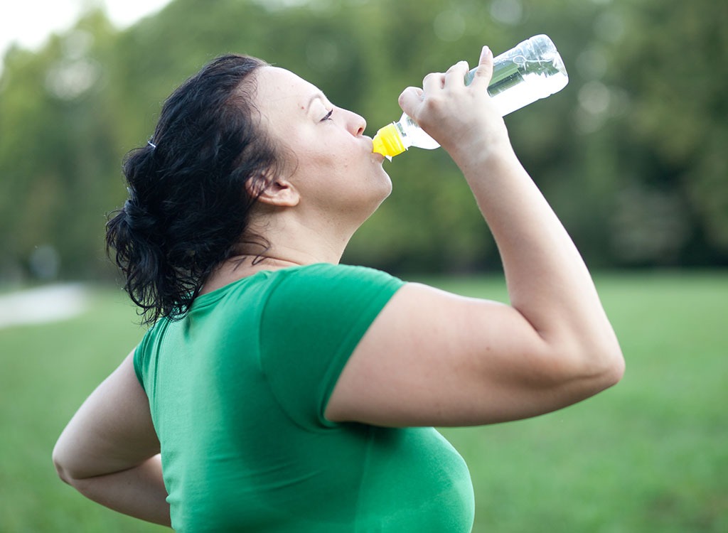 overweight woman drinking water