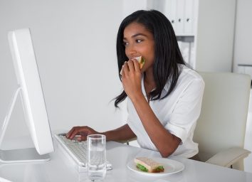 Woman eating at desk