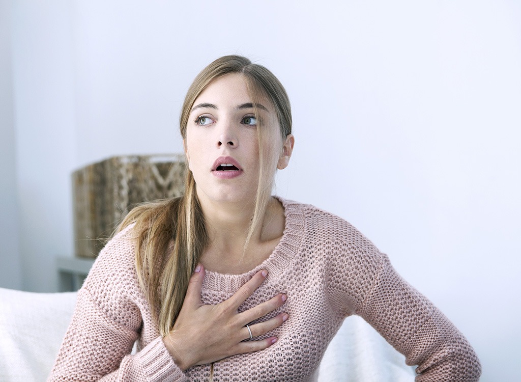 woman holding chest