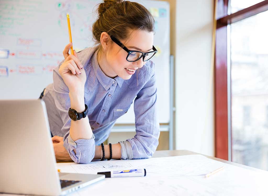 woman at work holding a pencil