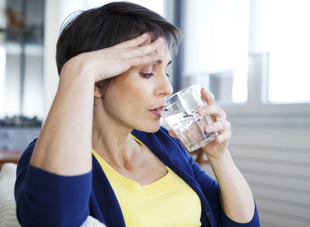 woman drinking water hot flash