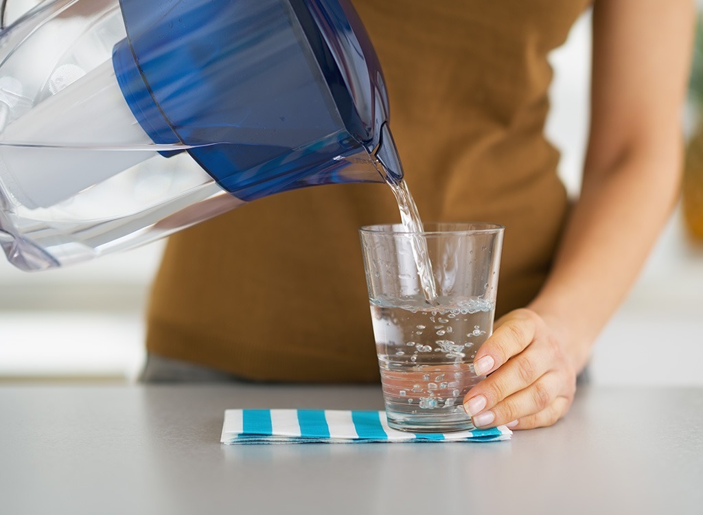 Woman pouring water into glass