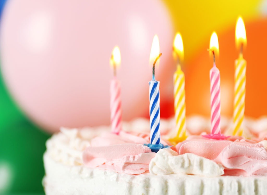 birthday cake with candles and balloons