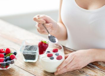 Woman eating yogurt and fruit