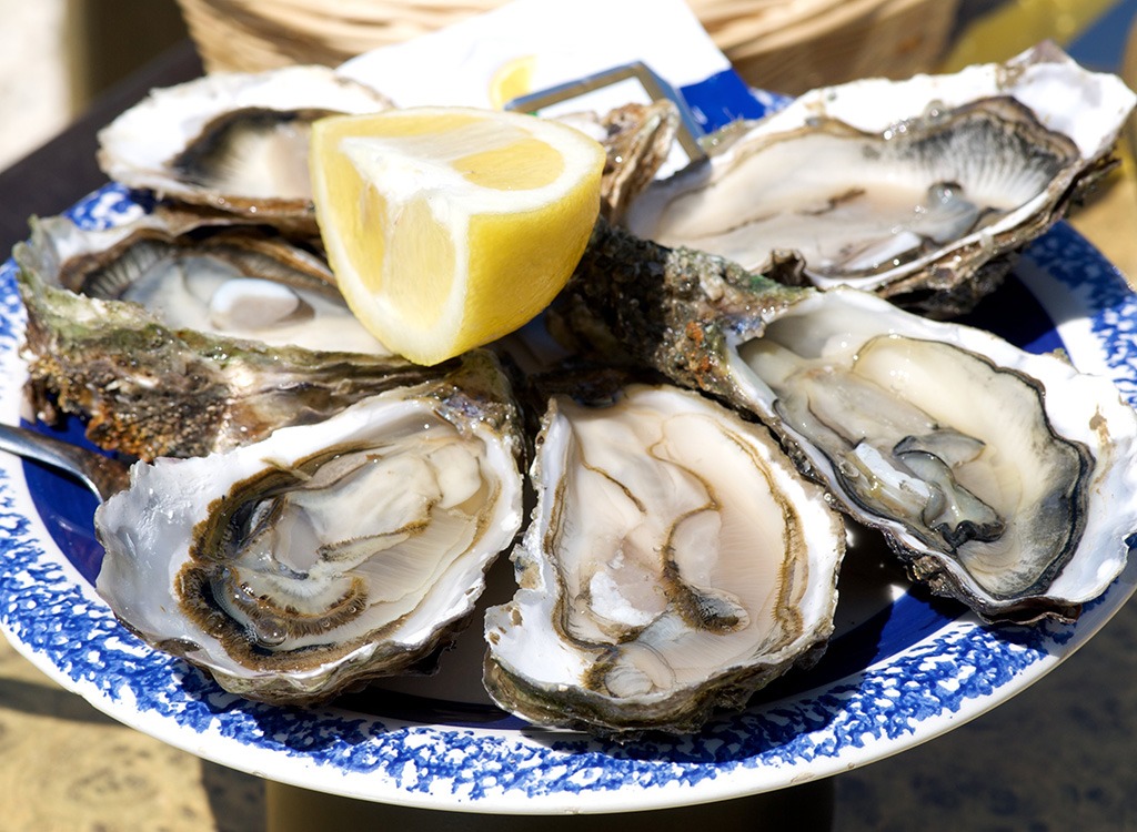 A plate of oysters with a slice of lemon, one of the many cold remedies