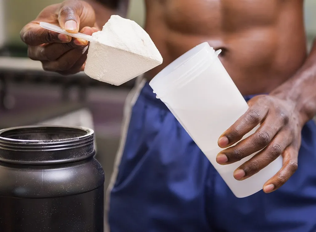 man making protein shake