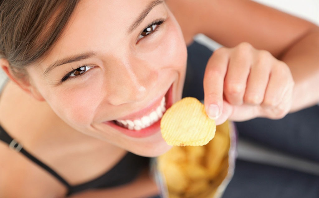 woman holding a potato chip