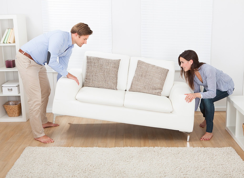 Couple moving furniture