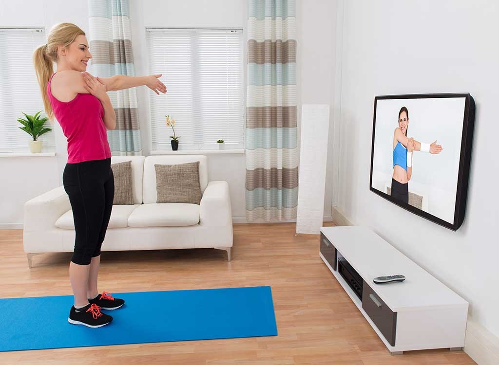 Woman working out in front of tv